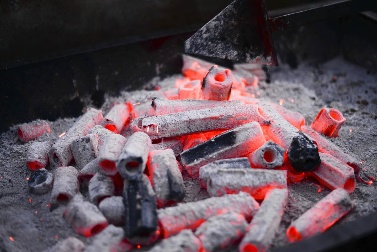 Smoldering hexagonal charcoal on hot barbecue